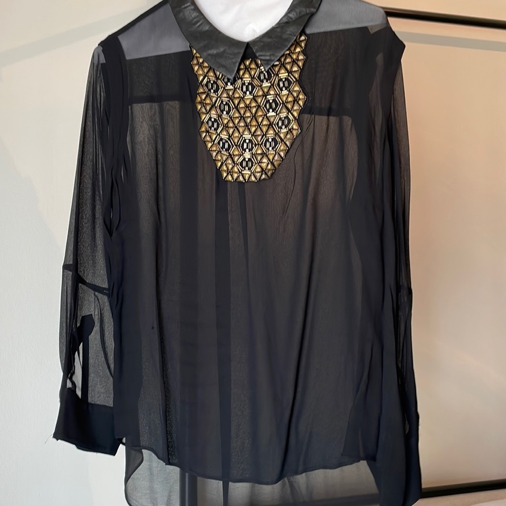 Sheer black blouse with leather color and neckline beading and studs.